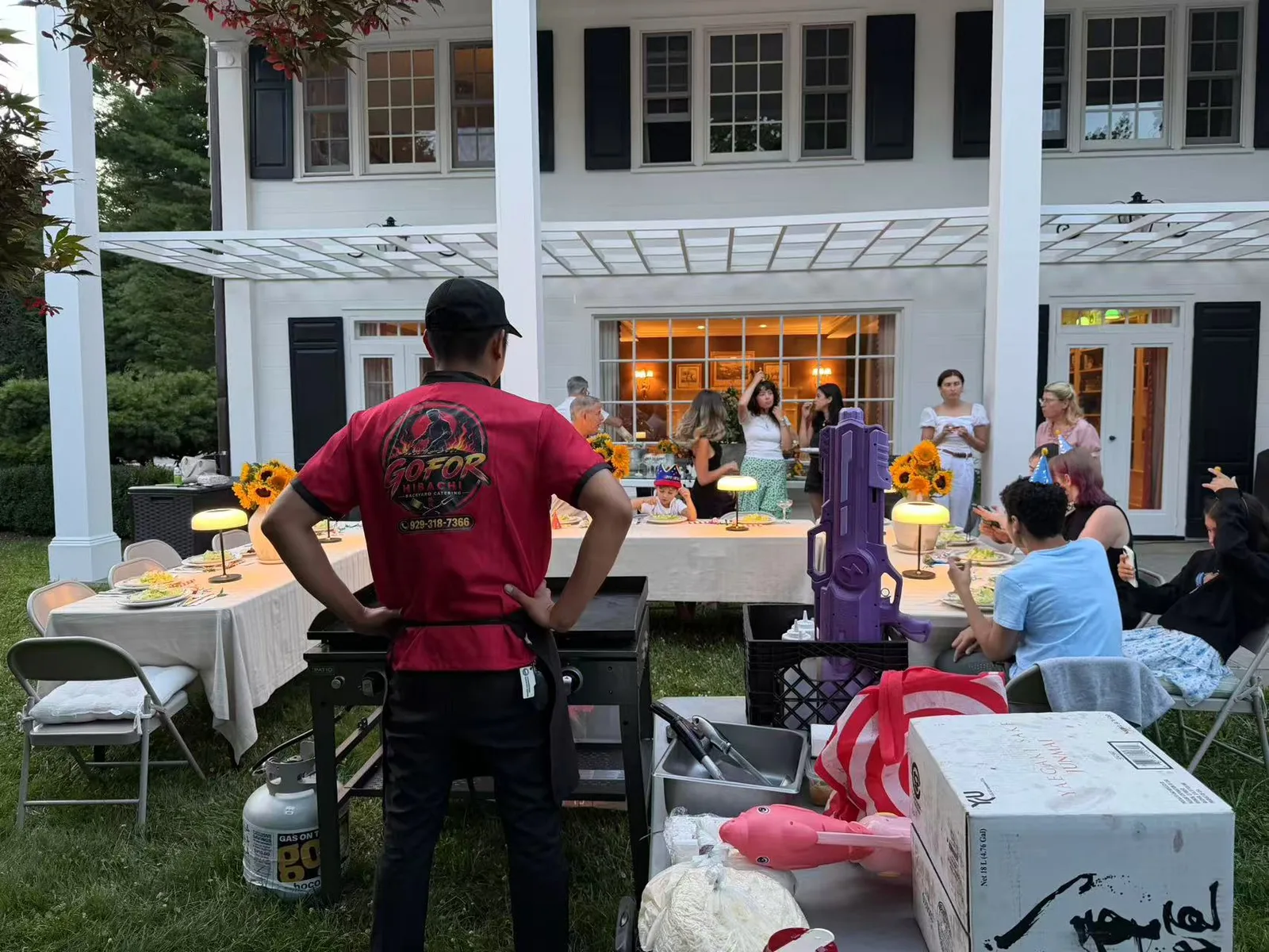 GoFor Hibachi private chef cooking at a long backyard dinner table in Rhode Island