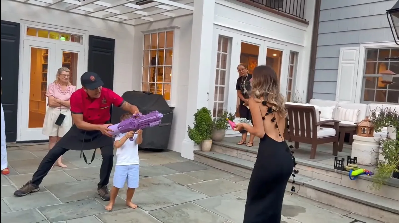 Chef helping a child hold a party prop at a family hibachi dinner in Rhode Island