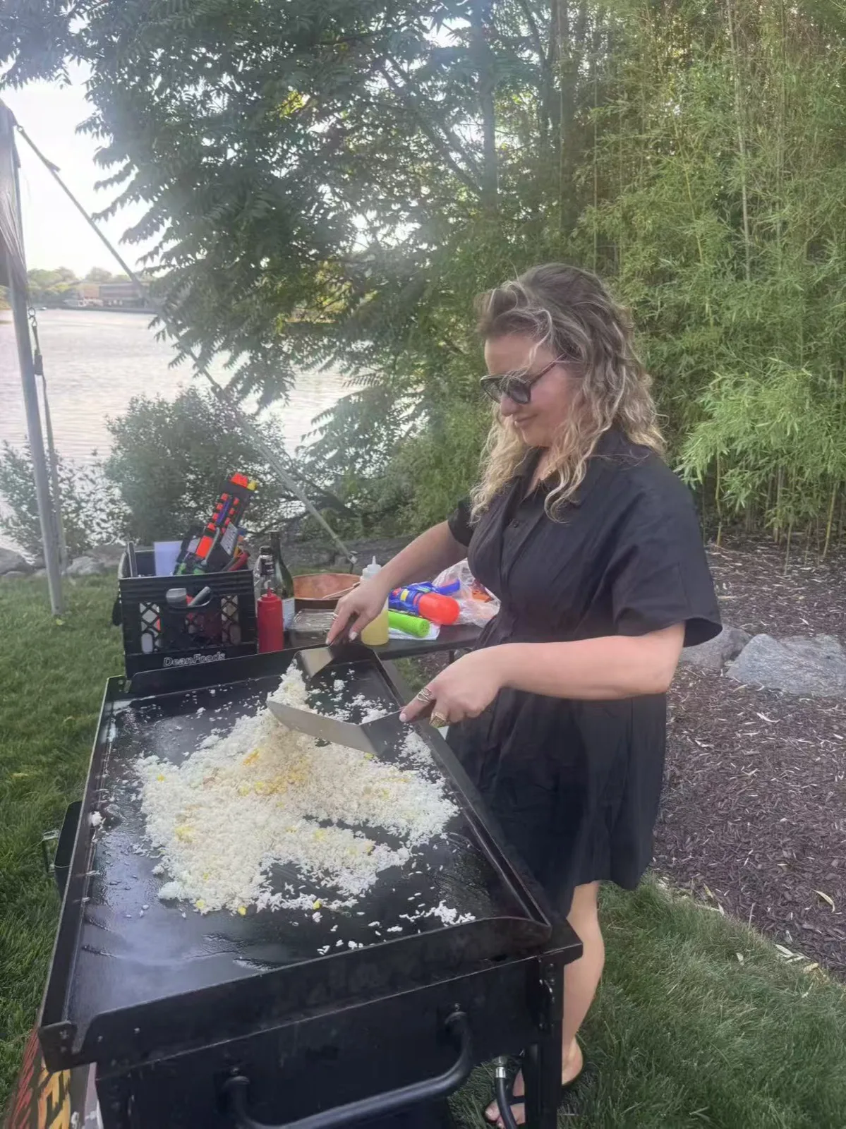 Tiger Hibachi chef cooking fried rice on the griddle beside a party tent in Rhode Island
