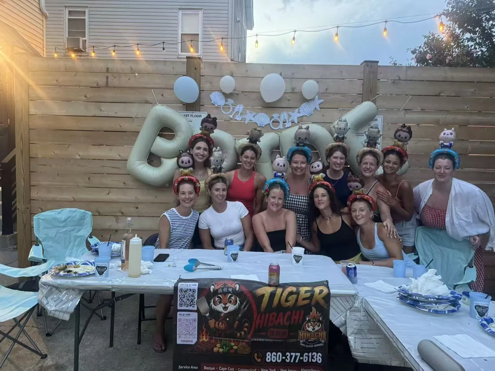 Large group of women posing together for a girls' night hibachi party in a Rhode Island backyard