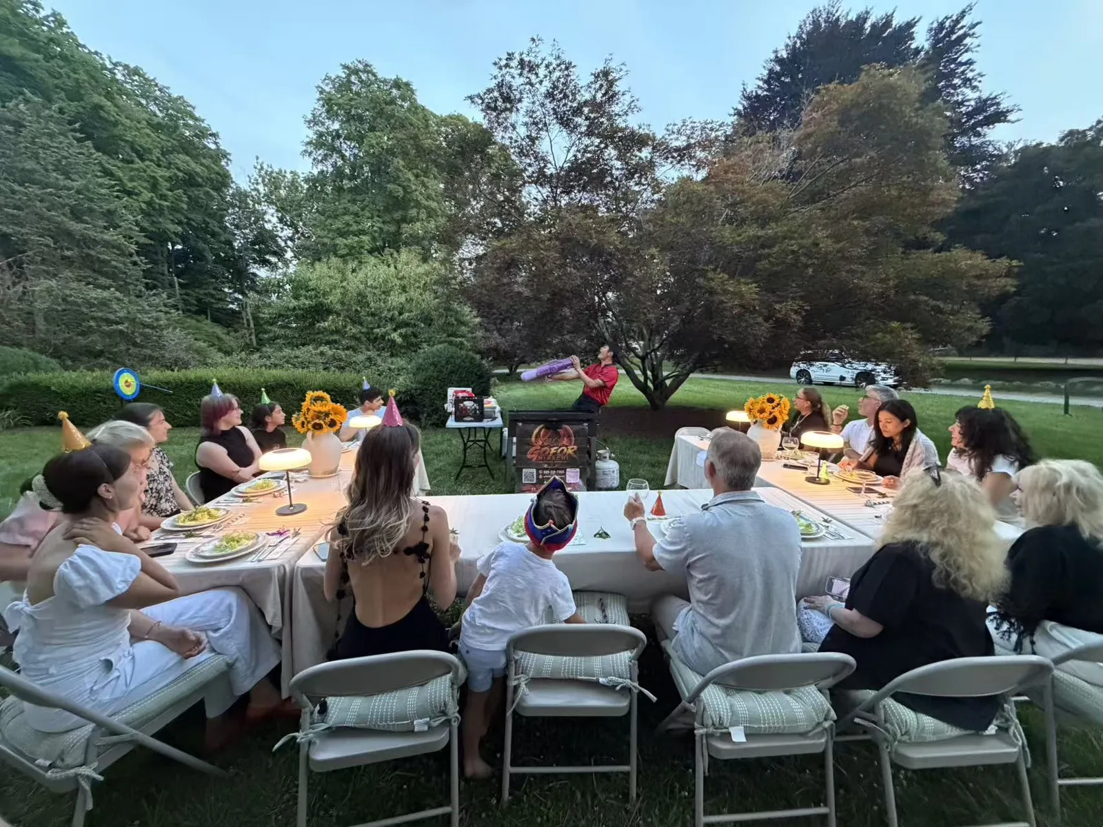 GoFor Hibachi chef cooking for a garden birthday party at dusk in Rhode Island