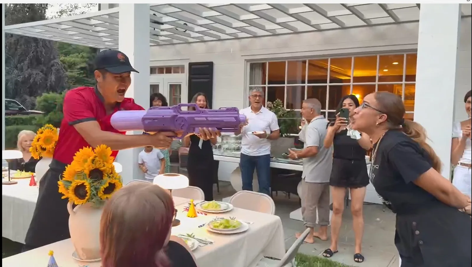 Hibachi chef entertaining a laughing guest at a backyard party in Rhode Island