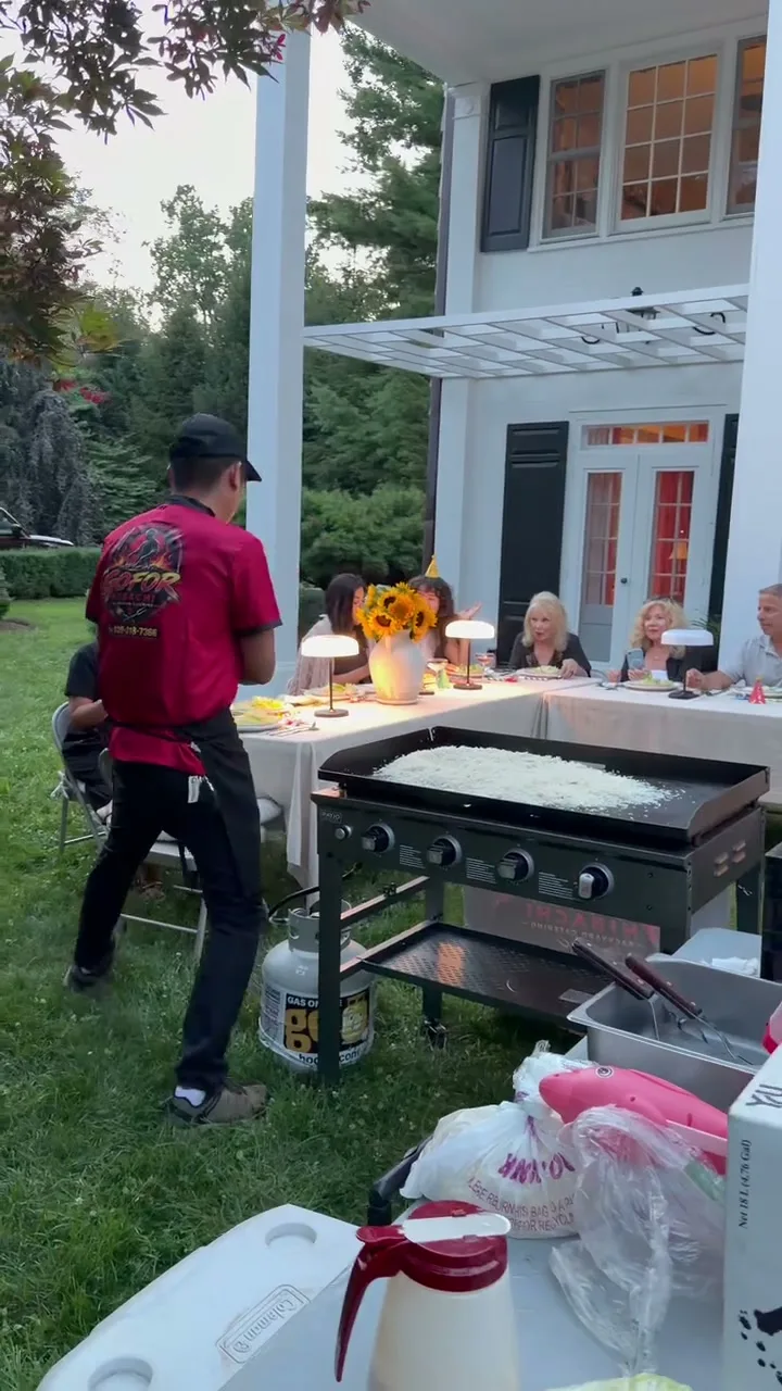 GoFor Hibachi chef cooking fried rice on the teppanyaki griddle at a Rhode Island party