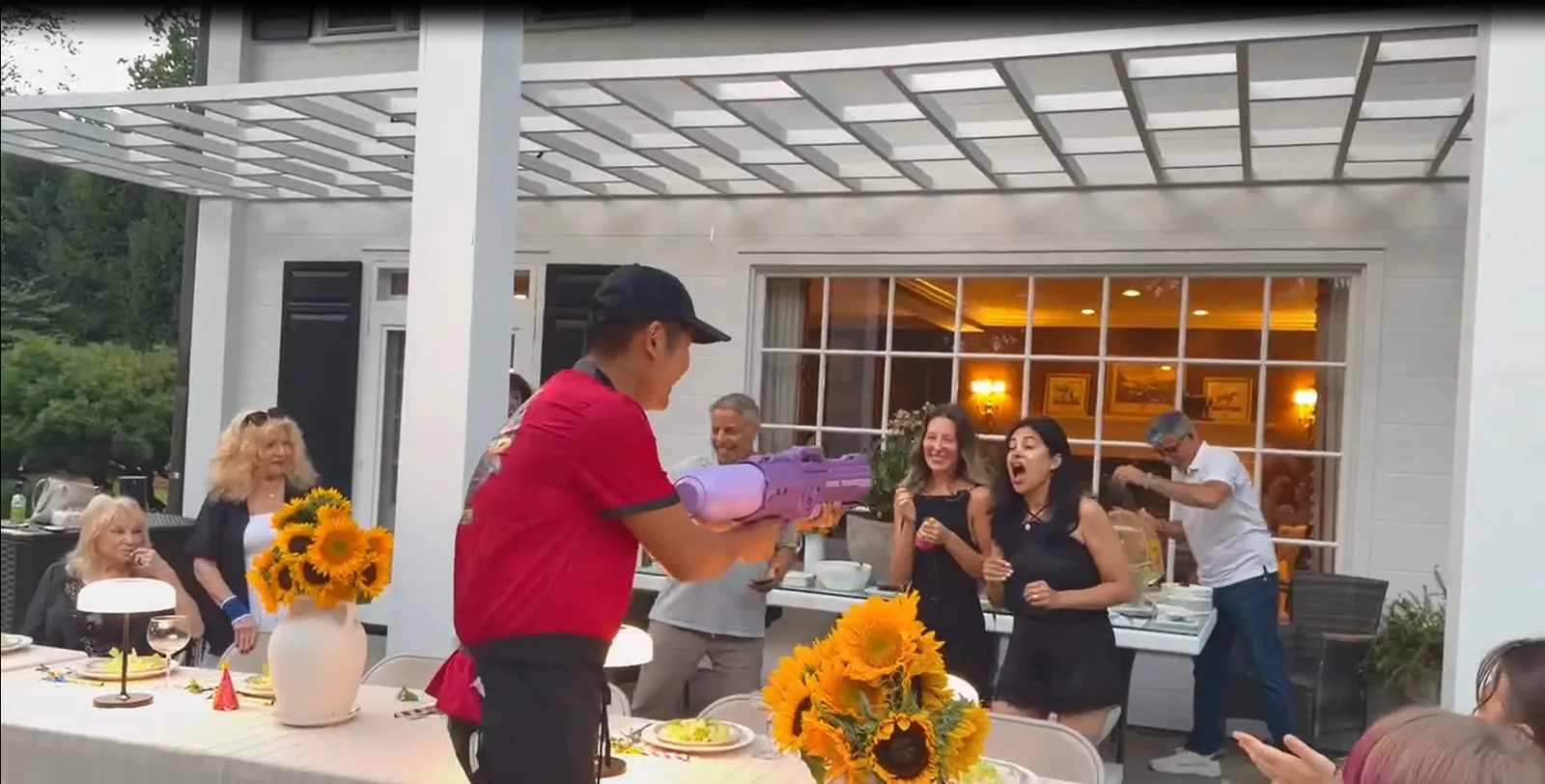 Guests seated at a hibachi dinner party table with the chef performing in Rhode Island