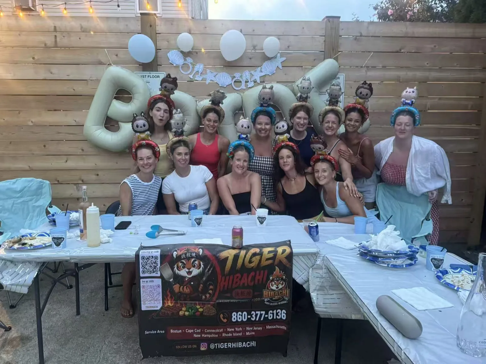 Large group of guests posing in front of a balloon backdrop at a Tiger Hibachi party in Rhode Island