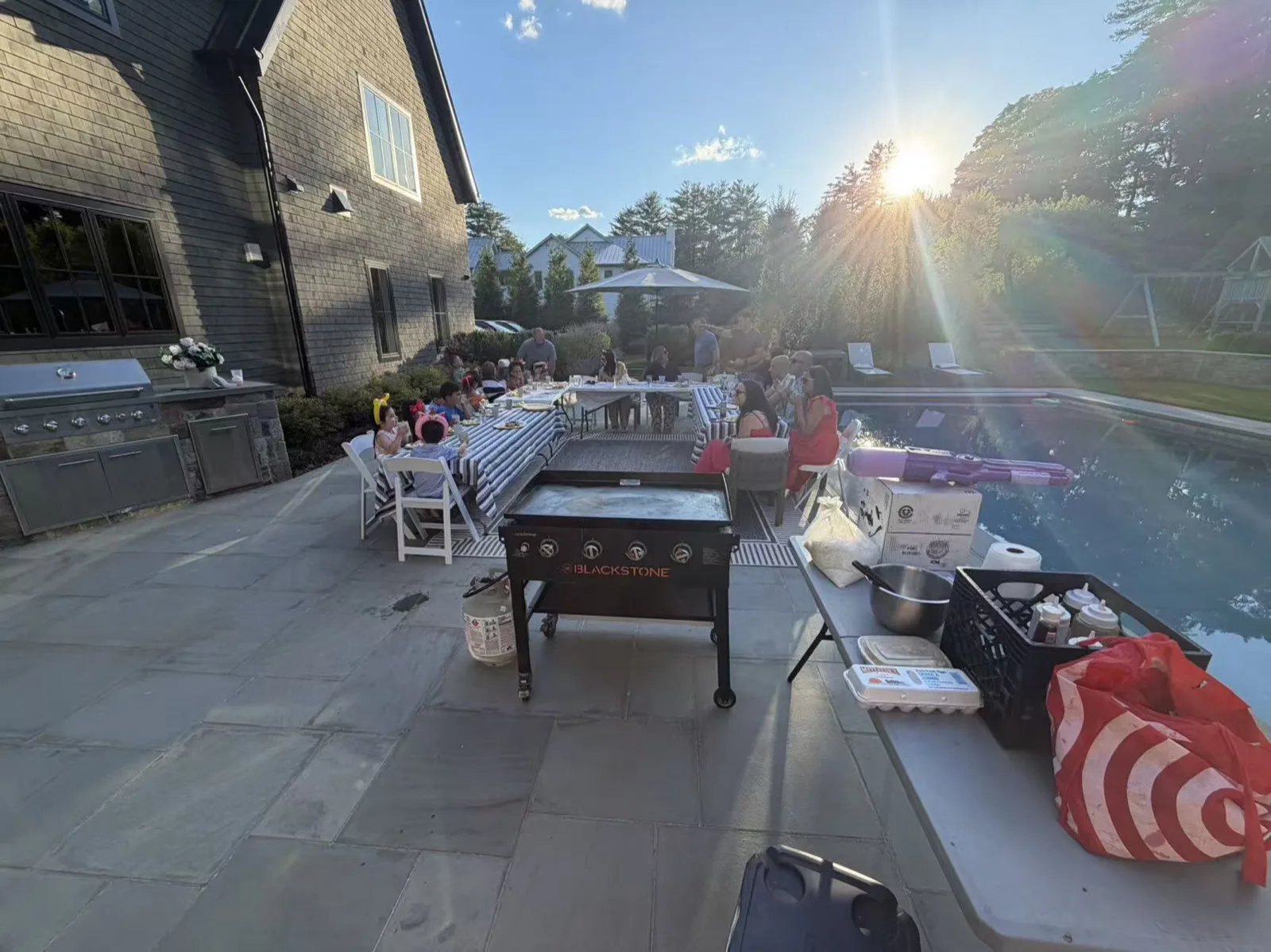 Sunset light over a poolside patio set up for a Tiger Hibachi party in Rhode Island